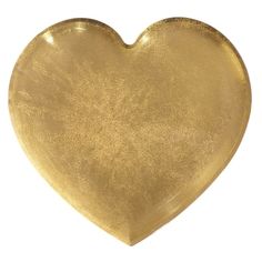 a gold heart shaped dish on a white background