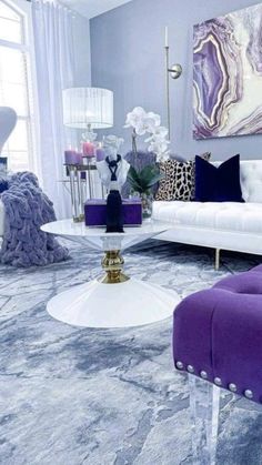 a living room with purple and white furniture