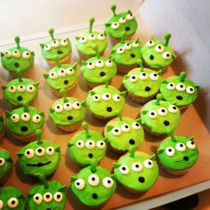 cupcakes with green frosting decorated as angry birds and eyes are on a tray