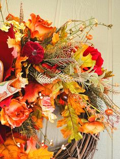 Add a touch of elegance to your home this fall with this handcrafted grapevine wreath. Featuring vibrant autumn roses, lush foliage, and a rich velvet ribbon, this wreath makes the perfect statement for your front door or entryway. The combination of warm orange, red, and gold tones creates a stunning display of fall beauty. Whether you're decorating for the season or Thanksgiving, this wreath is an inviting addition to your home decor. Its natural grapevine base adds rustic charm, while the bold florals and ribbon provide a unique, handcrafted touch. Ideal for any autumn-themed decor or as a welcoming gift for loved ones. Hang this beautiful wreath indoors or outdoors and let it bring the warmth of fall into your home. Dimensions: 26" long x 19" wide Enjoy 10% off your first purchase! Joi Autumn Roses, Double Door Wreaths, Floral Grapevine, Fall Beauty, Autumn Wreath, Spring Easter Decor, Themed Decor, Autumn Beauty, Autumn Wreaths