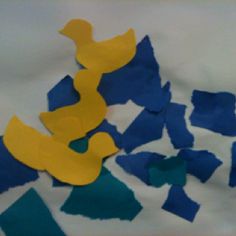 some blue and yellow pieces of paper on a table