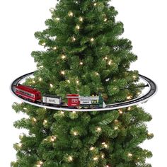 a christmas tree with a train set on the top and lights in the bottom half