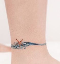 a starfish tattoo on the ankle with water splashing around it and an ocean wave