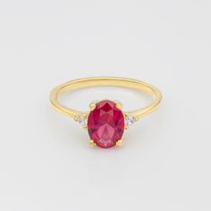 Get ready to add some serious bling to your jewelry collection with this amazing gold ring! Featuring a gorgeous oval cut ruby gemstone and two cute diamonds, this ring is sure to make heads turn. The ruby's rich red color is absolutely stunning and is sure to make you feel like royalty. The two diamonds add a little bit of sparkle to the piece, giving it a subtle but chic touch. Plus, the ring is super comfortable to wear, so you can rock it all day long. Perfect for dressing up or down, this r Lab-created Oval Ruby Ring, Oval Lab-created Ruby Ring, Oval Lab-created Ruby Promise Ring, 14k Gold Ruby Ring With Brilliant Cut Oval Shape, Oval Brilliant Cut Ruby Ring In 14k Gold, Oval Ruby Ring With Brilliant Cut For Gift, Oval Ruby Birthstone Ring With Prong Setting, Oval Ruby Ring With Brilliant Cut As Gift, Oval Ring With Lab-created Ruby And Accent Stones