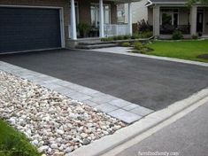 a driveway with rocks and gravel in front of a house