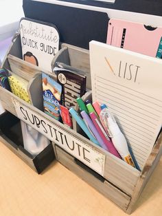 an office desk with some writing supplies in a bin on top of the desk,