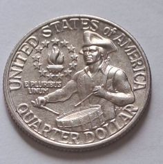 a silver coin with an image of a man in uniform on the front and side