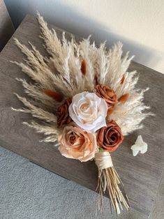 a bouquet of flowers sitting on top of a wooden table