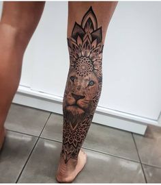 a man's leg with a tattoo on it and a lion in the middle