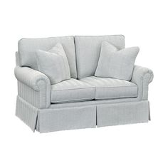 a white couch with two pillows on it's back and the arms folded down