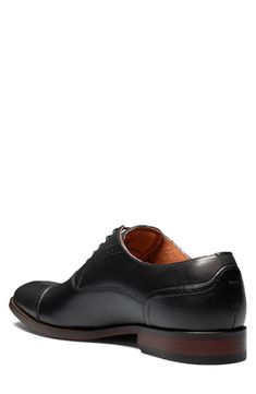 The Florsheim Sorrello Cap Toe Oxford features a modern, tapered toe, and rich burnished finish. Featuring breathable, full leather uppers, breathable suedetec linings, a fully cushioned footbed, and flexible rubber sole. Lace-up vamp Leather upper, rubber sole Imported Black Goodyear Welted Fitted Derby Shoes, Black Goodyear Welted Derby Shoes, Fitted Plain Toe Dress Shoes With Leather Footbed, Fitted Dress Shoes With Leather Footbed And Plain Toe, Fitted Dress Shoes With Leather Footbed, Fitted Derby Shoes With Leather Lining And Round Toe, Fitted Round Toe Derby With Leather Lining, Fitted Leather-lined Derby With Round Toe, Fitted Business Oxfords With Cushioned Footbed