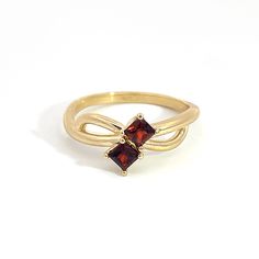 0.14 ct Princess Cut Garnet Two Stone Ring in 10K Gold Two princess cut Almandine Garnet (3.3mm x 3.3mm) in 4 prong setting 1.75mm 10K Yellow Gold novelty band Engraved with the affirmation "MM Luvs U" Charged in signature crystal grid and infused with Reiki for generational blessings (click for custom crystal grid charging and intuitively focused Reiki ) Handmade in Los Angeles using domestically sourced gold and Mozambique Garnet. This ring is size 7.0 but will be resized to fit you! Please sp Classic Formal Stackable Birthstone Ring, Princess Cut Birthstone Rings For Formal Occasions, Formal Stackable Round Cut Birthstone Ring, Stackable Round Cut Birthstone Ring For Formal Occasions, Classic Princess Cut Ruby Promise Ring, Formal 14k Gold Princess Cut Birthstone Ring, Generational Blessings, Black Owned Jewelry, Two Stone Ring