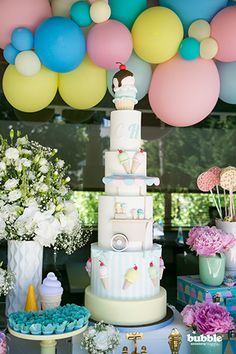 there is a cake and cupcakes on the table