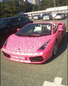 a pink sports car covered in leopard print