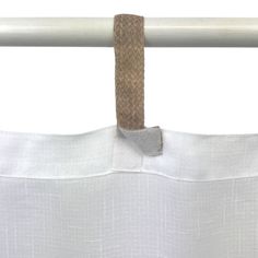 a white curtain with a brown tie hanging from it's grommet rod