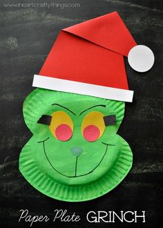 a paper plate grin face with a santa hat on it