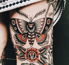 the back of a woman's stomach with tattoos on it and an image of a butterfly