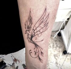 a black and white bird tattoo on the leg