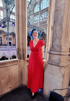 a woman in a red dress and blue hair