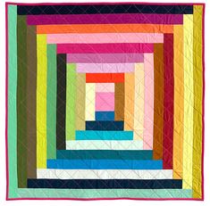 a multicolored quilt is hanging on a white wall and it's square