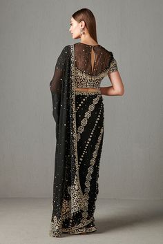 Black chiffon saree in sequin work. Paired with an embroidered blouse.
Component: 2
Pattern: Embroidered
Type Of Work: Sequin work
Neckline: Halter neck
Sleeve Type: Sleeveless
Fabric: Chiffon
Color: Black
Other Details: 
Sheer panel blouse
Tassel hem saree
Occasion: Sangeet - Aza Fashions Black Chiffon Saree, Sarees Black, Black Chiffon, Blouse For Women, Chiffon Saree, Saree With Blouse, Blouse Online, Embroidered Blouse, Aza Fashion