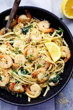 a skillet filled with pasta and shrimp