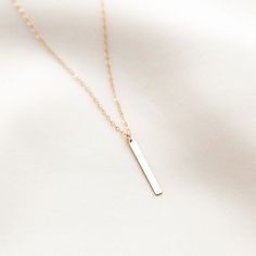 The Hanging Bar Necklace is simple, sleek, and modern. It's the perfect chic accessory to wear from the gym, to the beach, to dinner with friends! The sparkle from the dainty charm is sure to add a touch of style and confidence to any part of your day. DETAILS Necklace length: 18" with 2" extender 14k gold filled -or- sterling silver bar charm (26mm x 2.6mm) 14k gold filled -or- sterling silver charm, chain, & findings Safe for sensitive skin & shower safe Dainty Jewelry Necklace, Love Knot Ring, Necklace Outfit, Karma Necklace, Detailed Necklace, Hanging Bar, Charm Chain, Gold Bar Necklace, Dinner With Friends