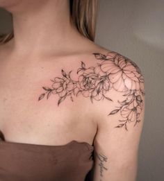 a woman's shoulder with flowers on it