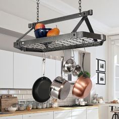 pots and pans hanging from a rack in a kitchen