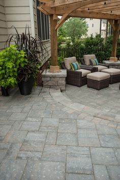 an outdoor patio with seating and potted plants