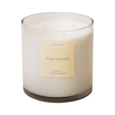 a white candle with a label on it