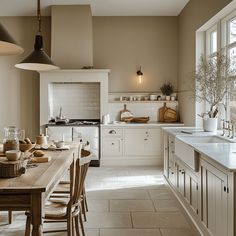 a kitchen filled with lots of white appliances and counter top next to a dining room table