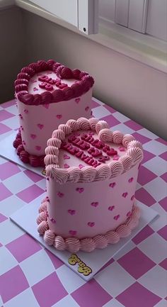 two pink cakes sitting on top of a table