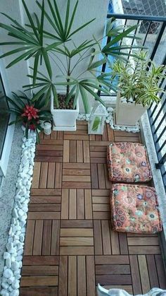 small balcony with wooden flooring and potted plants