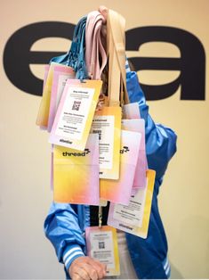 a person holding up several different colored tags