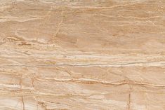 a close up view of a beige marble textured wall or floor tile with lines in the middle