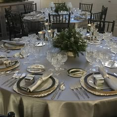 the table is set with silverware and place settings