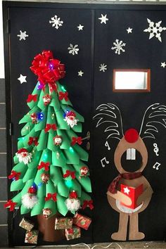 a door decorated with christmas decorations and a reindeer holding a present in front of it