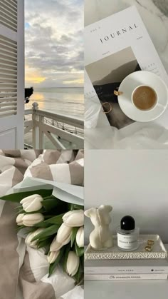 there is a coffee cup and some flowers on the table next to the ocean with an open book