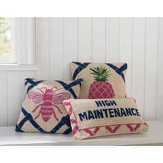 three pillows with embroidered pineapples on them and the words high maintenance printed on them