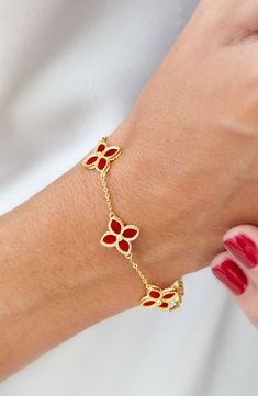 Bright gold beads frame four-petaled flowers on a delicate chain bracelet. 7" length with 1" extension 18K gold plated sterling silver, agate Lobster clasp Imported Luxury Red Flower Shaped Jewelry, Luxury Red Flower-shaped Jewelry, Elegant Red Flower Bracelets, Elegant Red Flower Bracelet, Loose Bracelet, Flower Station, Station Bracelet, Bead Frame, Delicate Chain