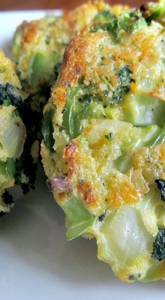 broccoli florets on a white plate with cheese and seasoning sprinkles