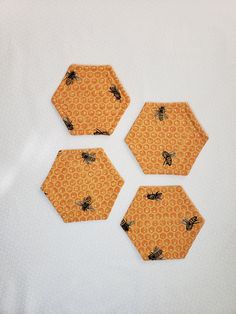 four honeycombs with bees on them are arranged in the shape of hexagons