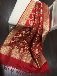 This is a beautiful bridal red pure katan silk banarasi kadwa jangla dupatta that is made for weddings!! Beautifully handwoven in golden zari, floral zari borders these floral jaal pattern on this red dupatta is truly stunning!! You just won't be able to take your eyes off it when you see it. This is a true testament to its' weaver's skill.  Don't wait! Own it today!! Length:232 cm Width:92 cm Kadwa weave requires skill and takes much longer to weave. Colour may vary slightly depending upon the Luxury Katan Silk Dupatta With Block Print, Elegant Luxury Katan Silk Dupatta, Luxury Banarasi Silk Pashmina Shawl With Zari Weaving, Luxury Katan Silk Block Print Dupatta, Luxury Katan Silk Dupatta, Luxury Katan Silk Dupatta For Rituals, Luxury Banarasi Silk Dupatta With Weaving Work, Luxury Katan Silk Lehenga With Zari Weaving, Luxury Banarasi Silk Dupatta With Printed Motifs