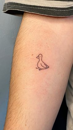 a small bird tattoo on the right thigh