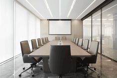 an empty conference room with chairs and a projector screen in the middle of it