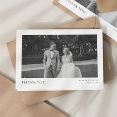 two thank you cards with an image of a bride and groom in formal attire on top of brown envelopes