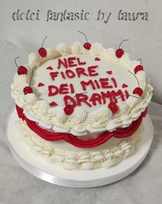 a white cake with red writing on it