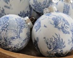 blue and white christmas ornaments in a wooden bowl