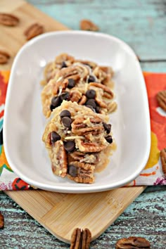 a white plate topped with cookies and pecans